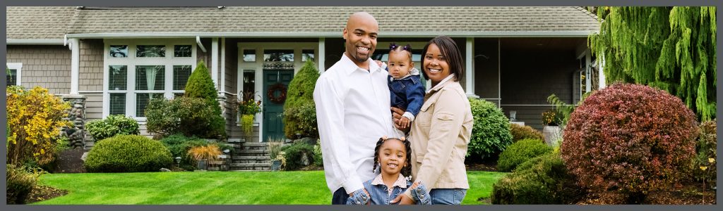 family standing in front of home